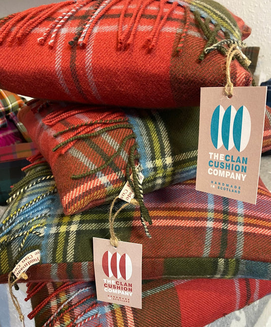 Stack of handmade tartan cushions with Clan Cushion Company swing tags