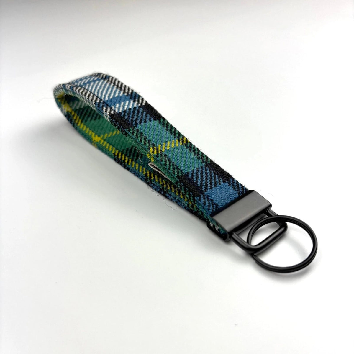 Handmade tartan keyring with black hardware, angled on a white background