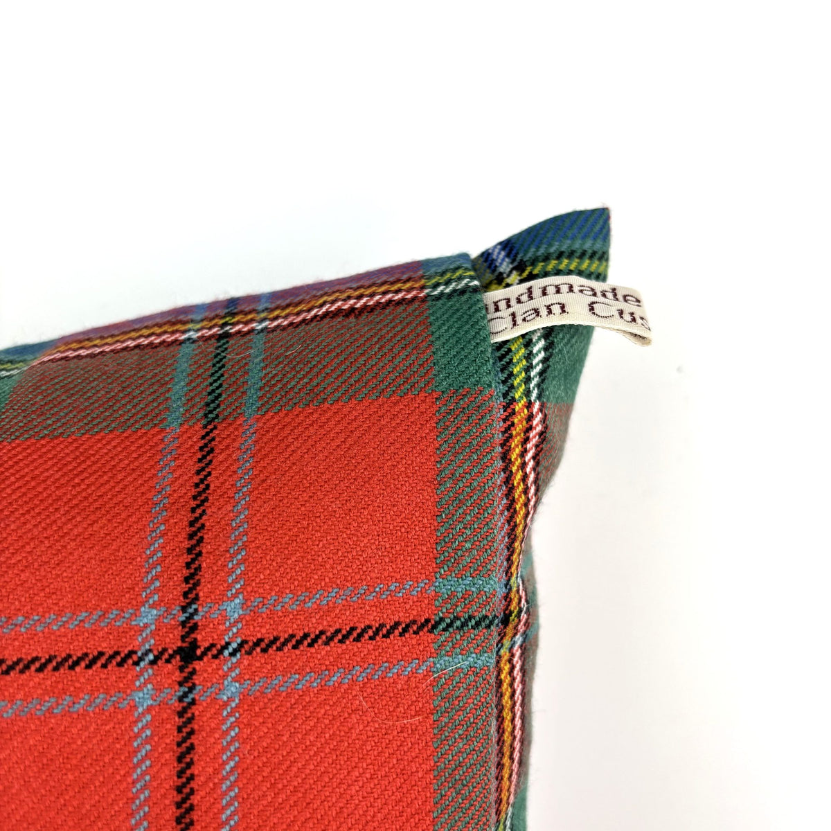 MacLean of Duart Ancient Tartan Cushion, angled corner on white, cream fabric label visible